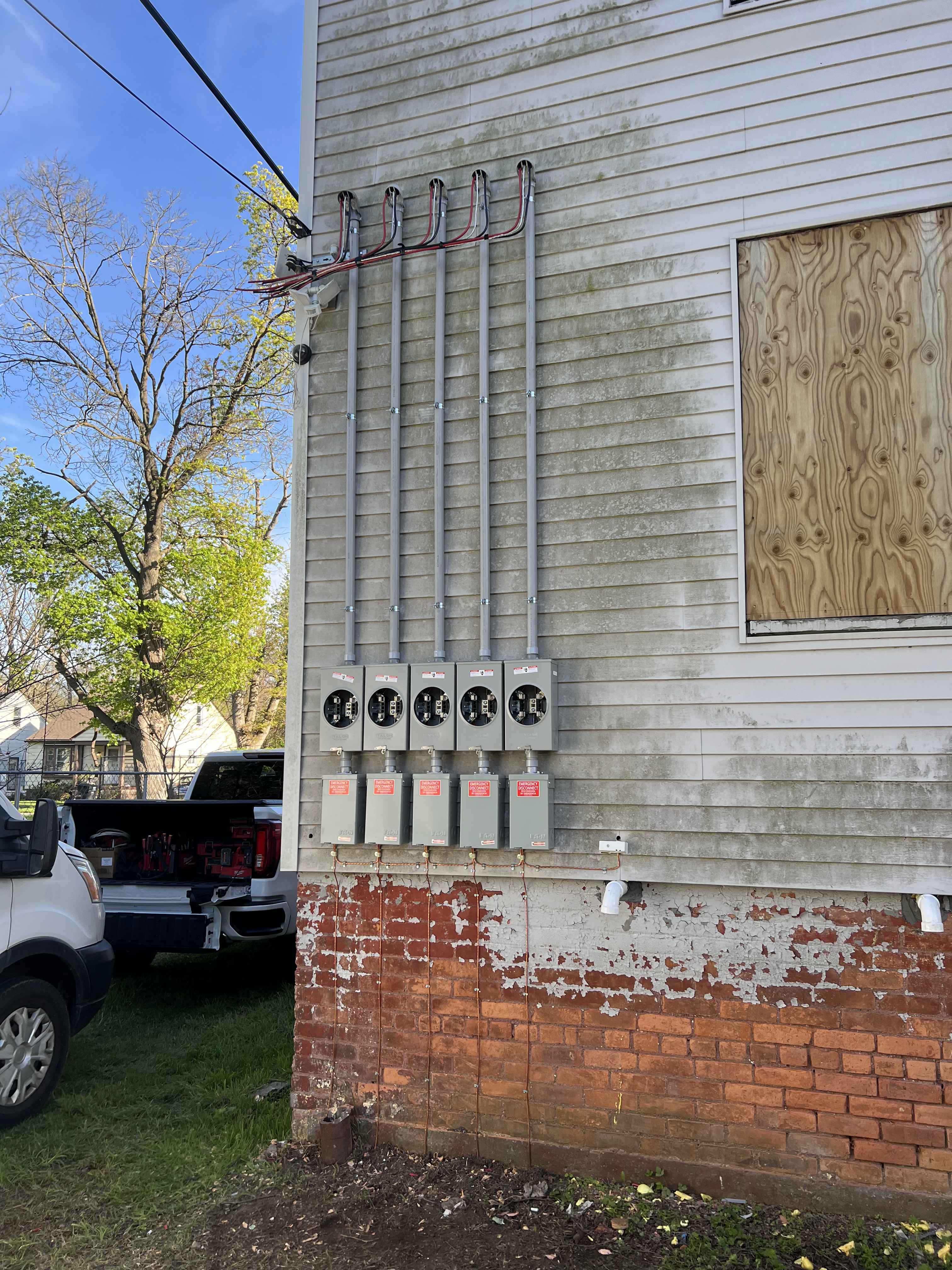 Commercial Multi-Meter Service Bank — Exterior multi-tenant meter pack with conduit risers